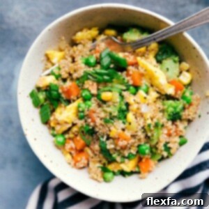 A serving of Quinoa Fried Rice in a bowl, showing the vibrant colors of the vegetables and fluffy quinoa, ready for enjoyment.