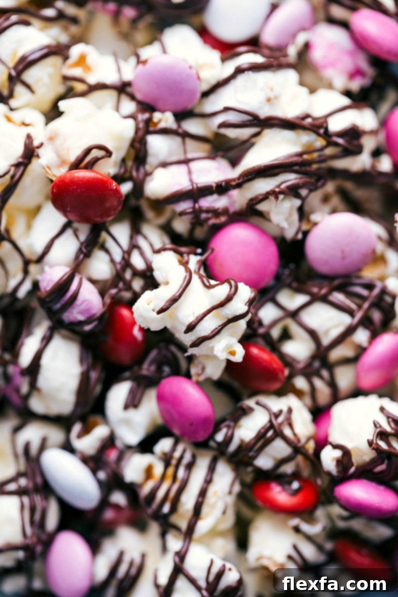 Close-up of delicious Valentine's Popcorn, richly covered in chocolate and adorned with colorful Valentine's M&M's.