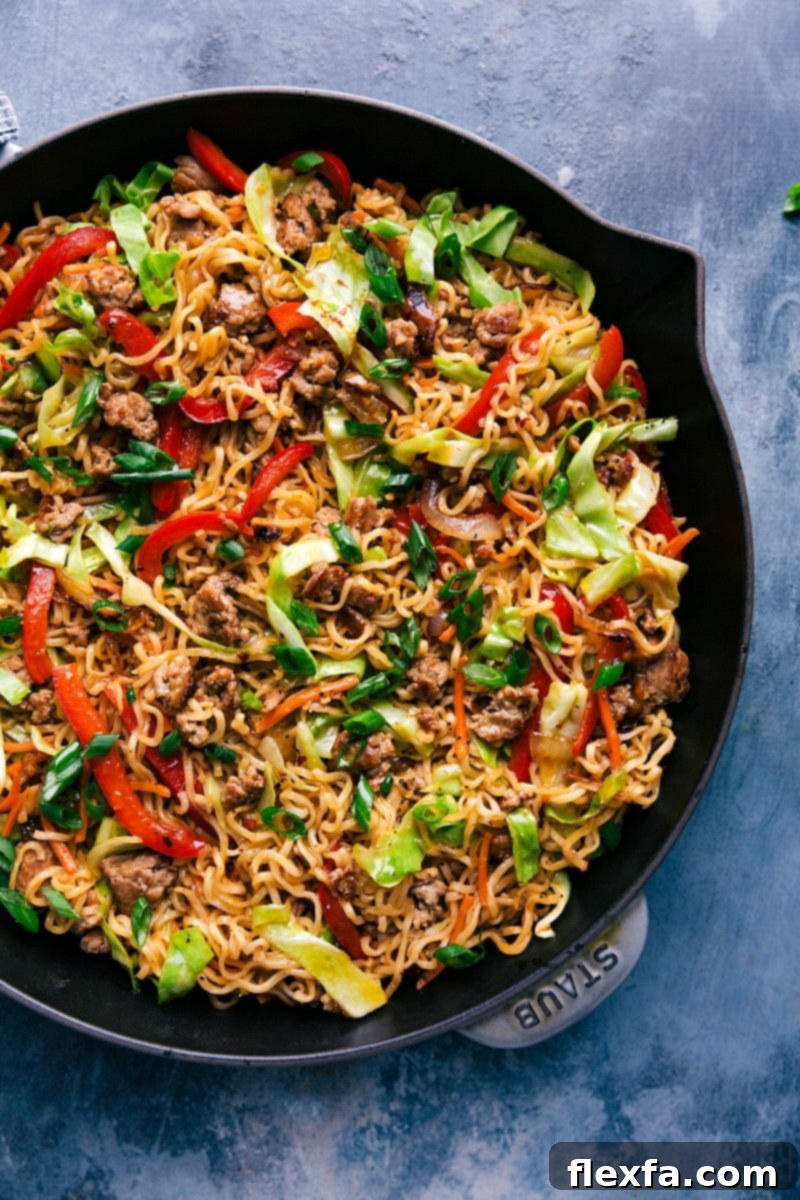 Completed Egg Roll Noodles in a large skillet, beautifully garnished with fresh green onions, ready to be served.