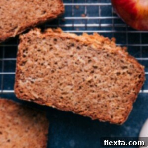 A delectable slice of homemade apple bread, showcasing its moist and tender crumb, ready to be enjoyed.
