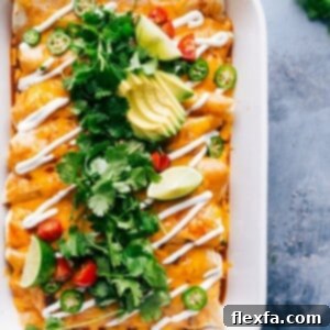 Sweet potato enchiladas with a delectable filling, topped with melted cheese, served in a dish.