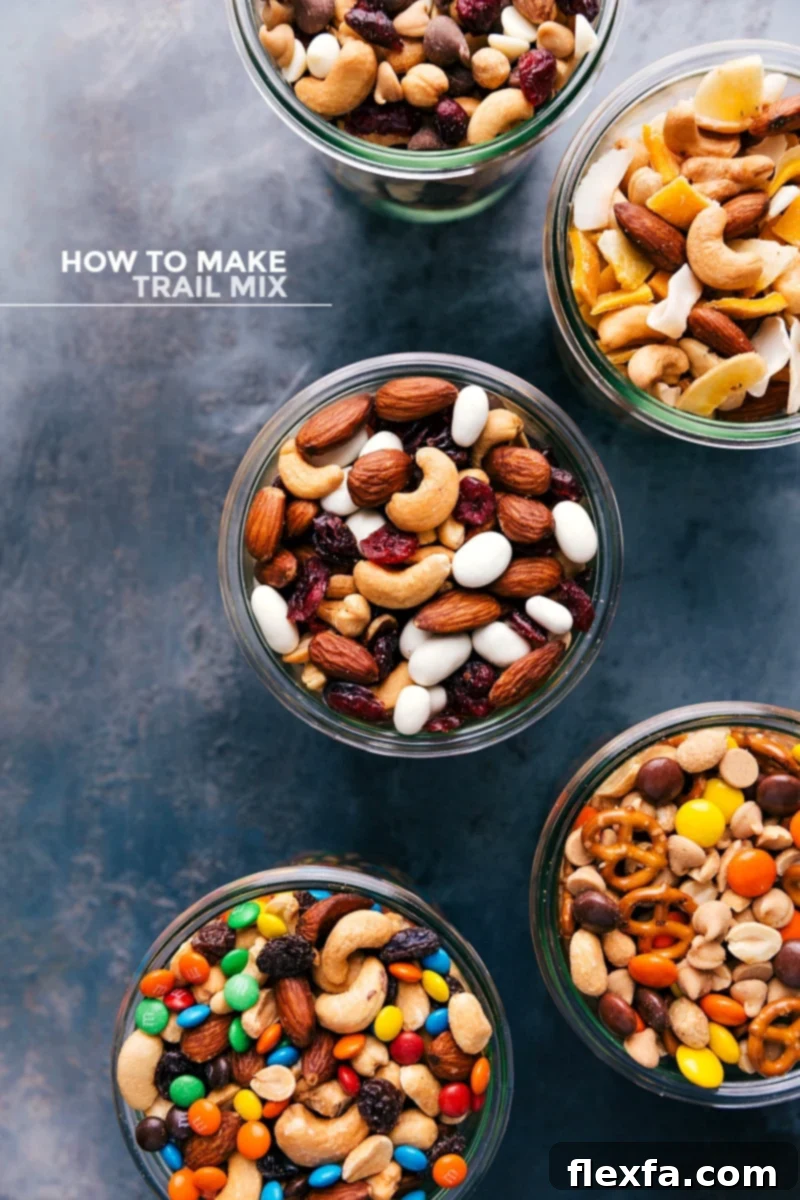 Assortment of five different types of delicious trail mix in clear glass jars, showcasing their vibrant ingredients and textures.