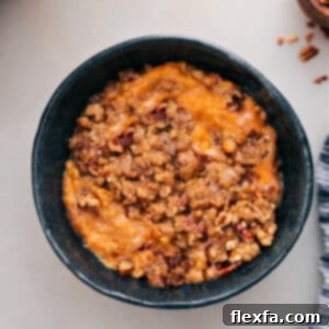 Close-up of the delicious Crockpot Sweet Potato Casserole, showcasing its creamy texture and crunchy pecan topping.