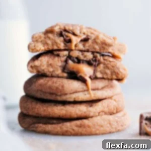 A stack of mouthwatering caramel snickerdoodles with centers oozing with melting caramel and chocolate.