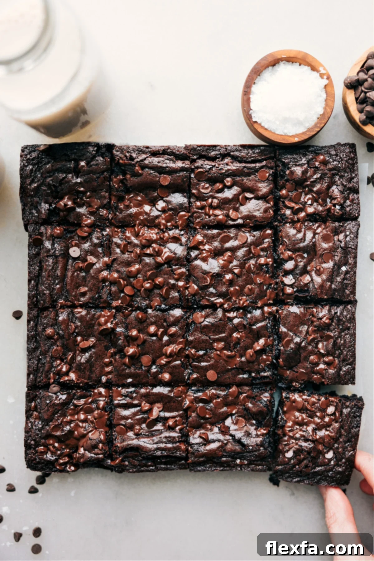 Fudgy Brownie Recipe: Perfectly cut squares of rich chocolate brownies, generously topped with mini chocolate chips, ready to be enjoyed.