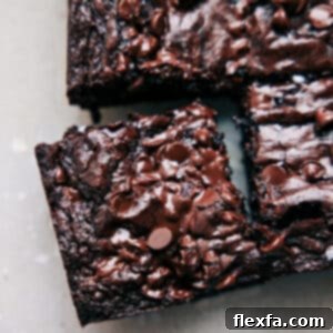 A delicious square of a freshly baked fudgy brownie, ready to be enjoyed.