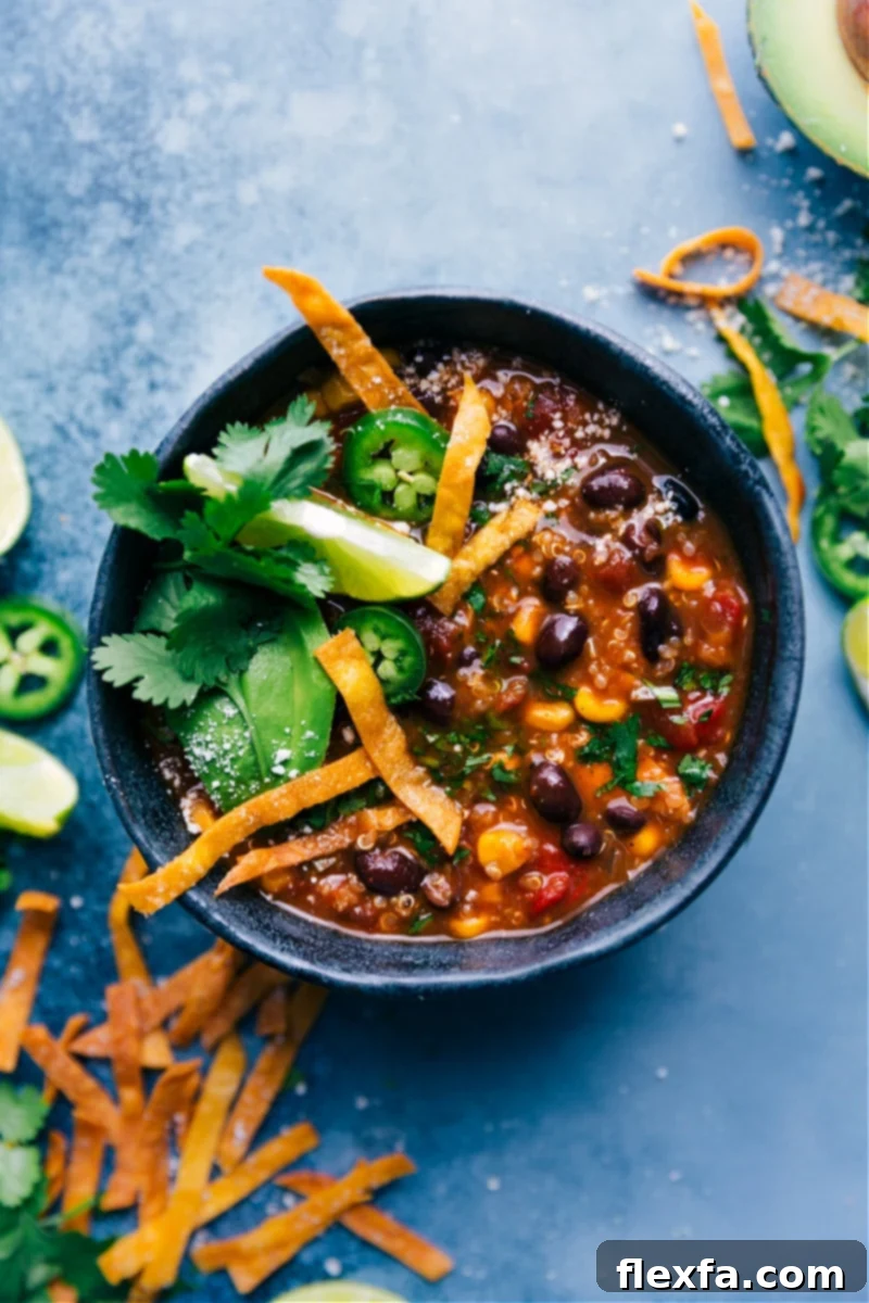 Overhead image of Healthy Chicken Tortilla Soup in a rustic bowl with toppings