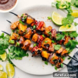 Close-up of a cooked Teriyaki Chicken Skewer, glistening with sauce and featuring perfectly grilled chicken, pineapple, and colorful vegetables.