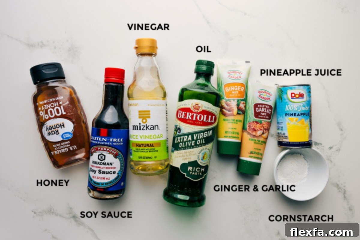 The marinade and sauce ingredients meticulously prepped and arranged, including golden honey, savory soy sauce, tangy vinegar, olive oil, fragrant ginger, minced garlic, sweet pineapple juice, and cornstarch for thickening.