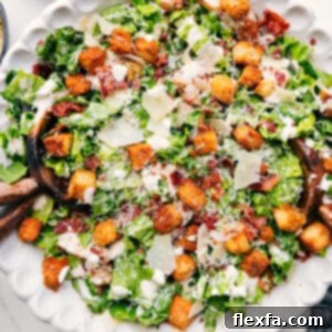 Close-up of a serving of Caesar Salad, showcasing its creamy dressing, crispy croutons, and fresh romaine.