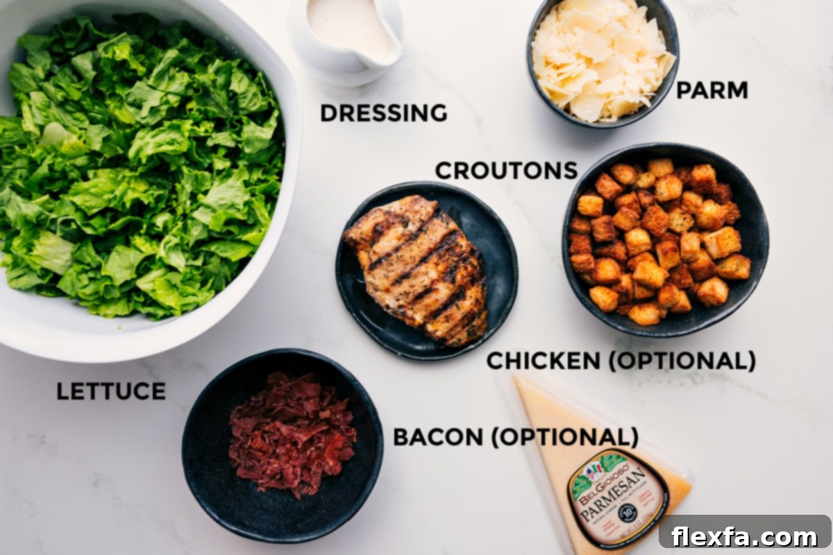 All the fresh ingredients laid out and prepped for assembling the Caesar salad: crisp romaine, creamy dressing, grated Parmesan, golden croutons, crispy bacon, and cooked chicken.