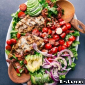 Platter of fresh, healthy salad drizzled with honey mustard salad dressing, inviting and ready to enjoy.
