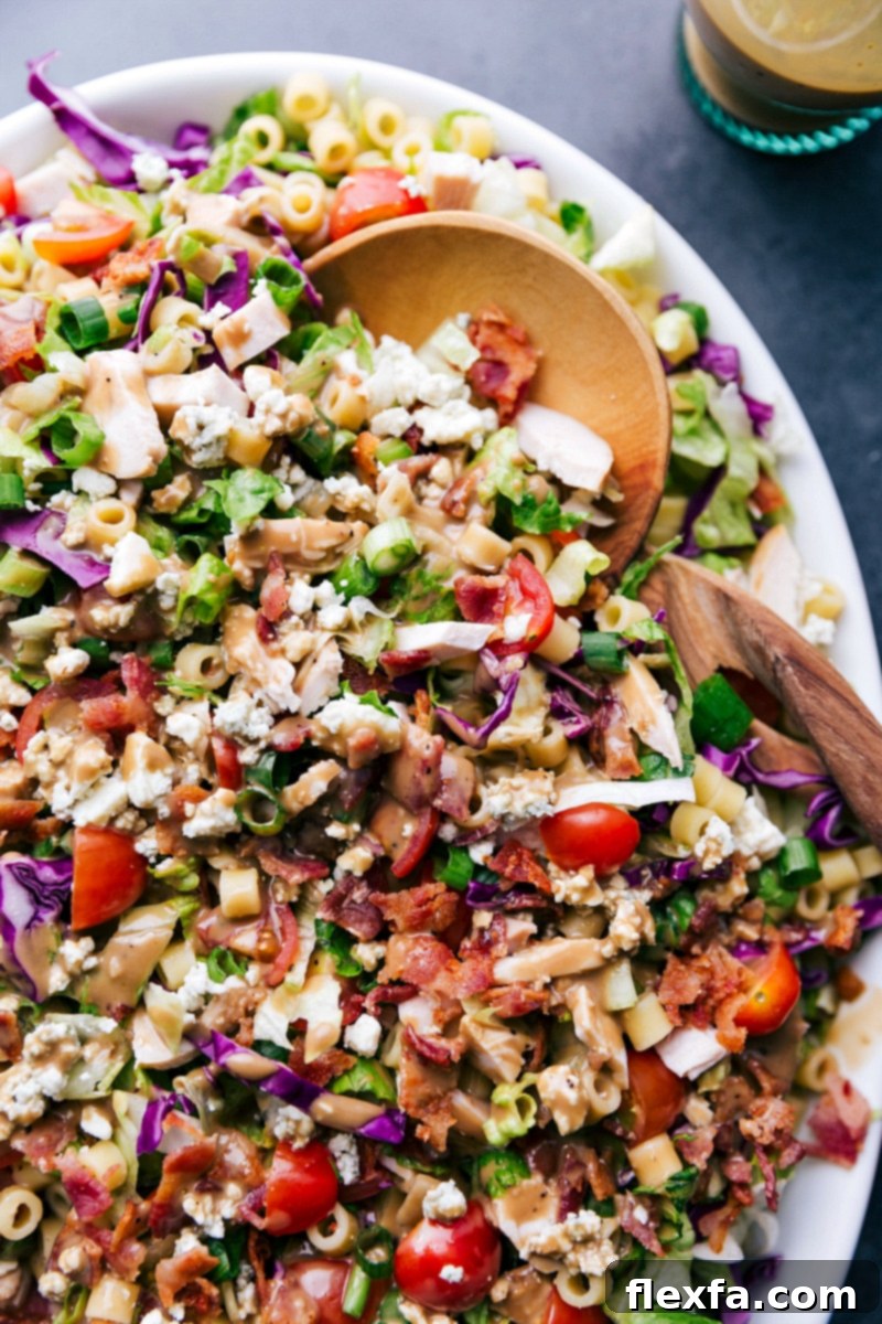 The fully dressed Portillo's Chopped Salad beautifully presented on a platter, ready to be enjoyed as a refreshing meal.
