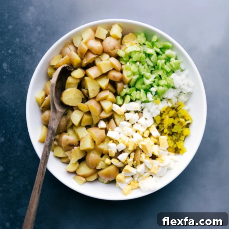 Finely diced celery, sweet onion, hard-boiled eggs, and tangy pickles are meticulously prepared, ready to be added as flavorful components to the potato salad recipe.