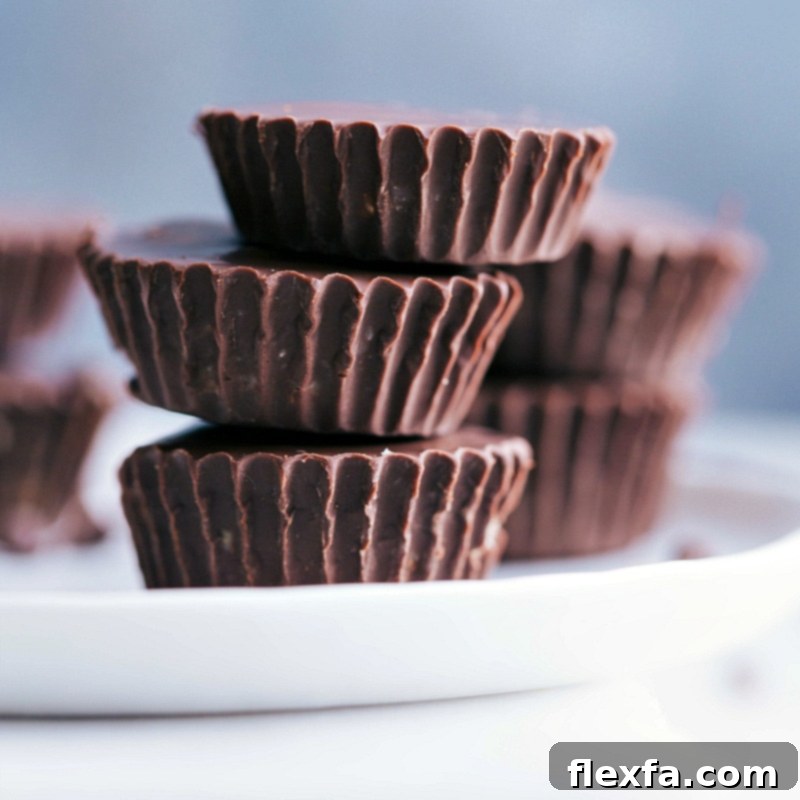 View of three Healthy Cookie Dough Cups stacked on a plate, highlighting their appealing texture.