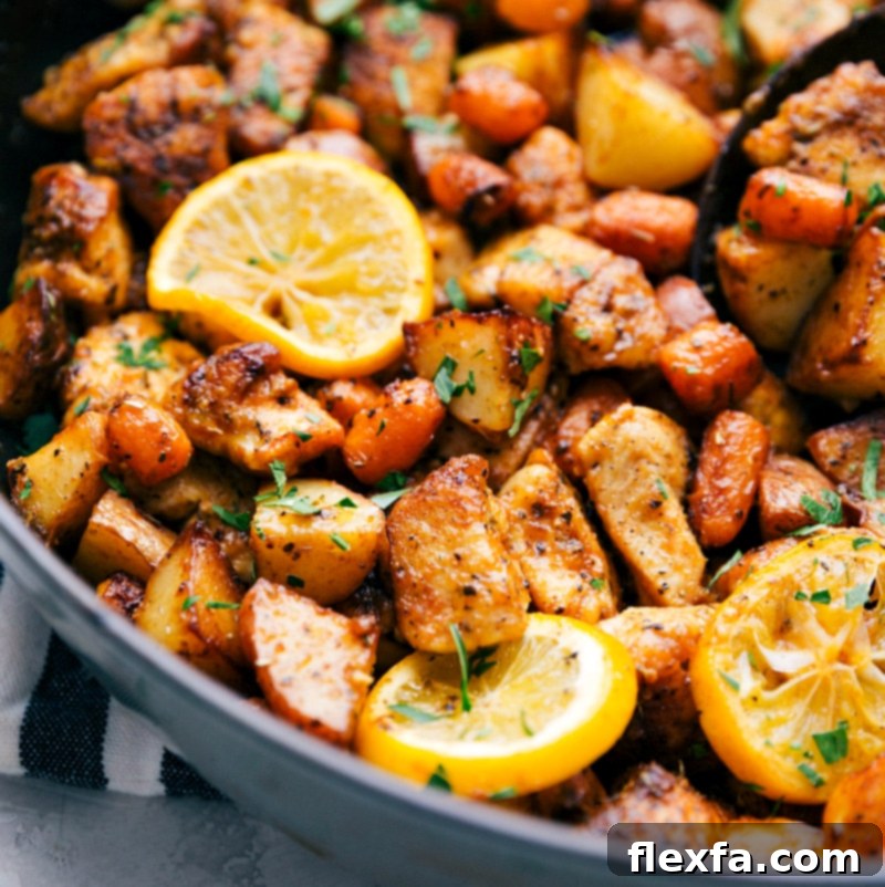 Close-up of the finished One-Skillet Lemon Chicken and Potatoes, garnished generously with fresh parsley and lemon slices.