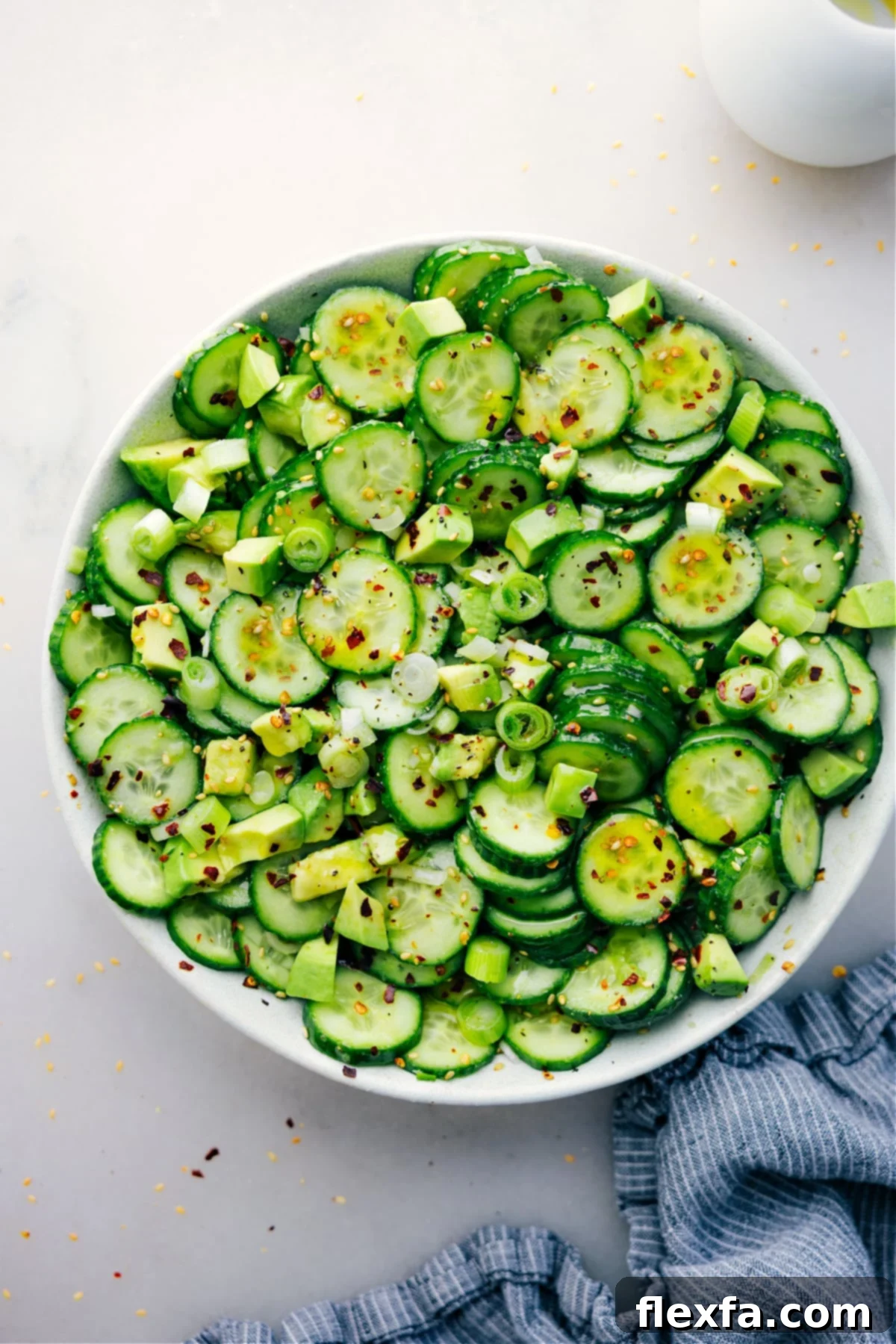 A beautifully presented bowl of Asian Cucumber Salad, garnished and ready to be enjoyed.