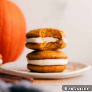 Beautifully assembled Pumpkin Whoopie Pies on a white plate, ready to be served.
