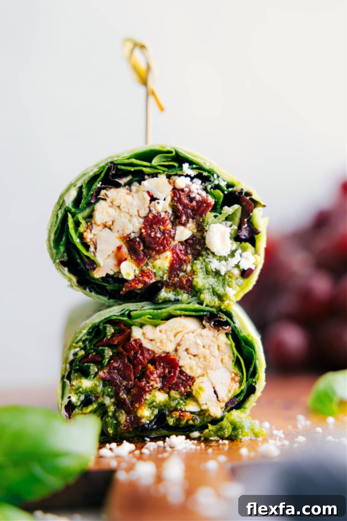 Mediterranean Wrap cut in half and stacked on top of each other, showcasing fresh ingredients.