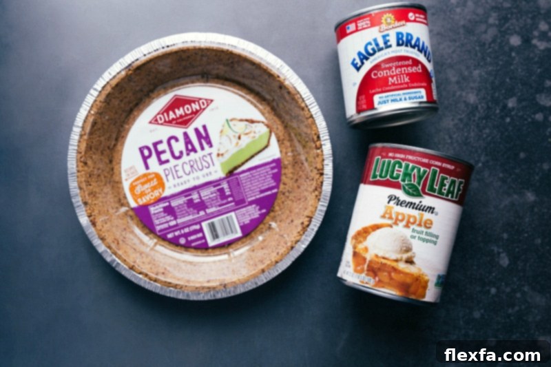 An array of high-quality ingredients including a pre-made pie crust, a can of apple pie filling, and sweetened condensed milk, key shortcuts for this Apple Streusel Pie recipe.