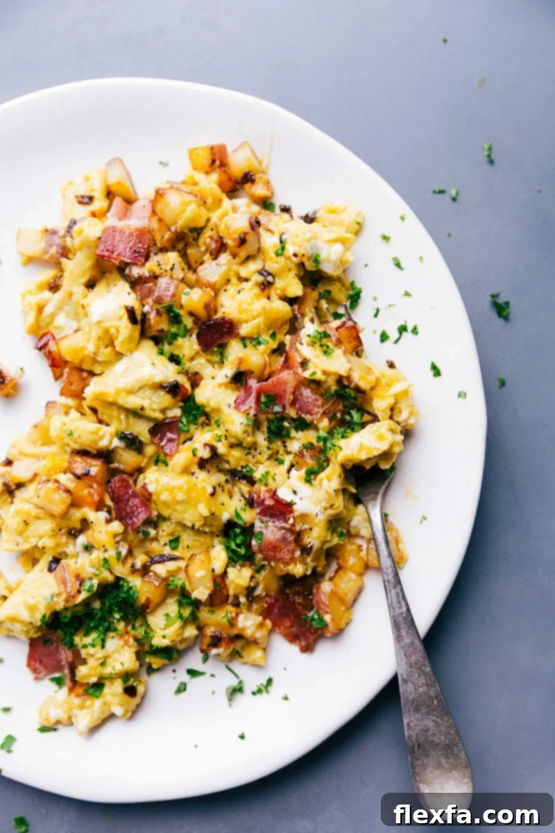 Savory Egg Skillet Garnished with Parsley, Served on a Plate and Ready for Consumption. Egg skillet on a plate garnished with fresh parsley, ready to eat, with a fork.