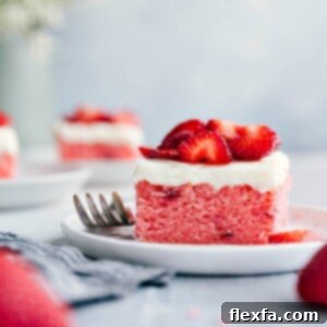 A delicious, homemade Strawberries and Cream Cake with cream cheese frosting and sugared strawberries.