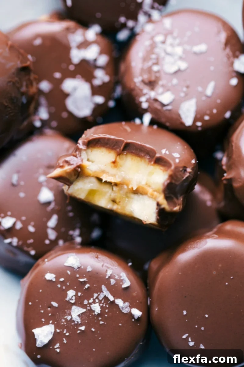 A delicious pile of Banana Bites, with one featuring a bite taken out, showcasing the creamy peanut butter and chocolate layers. Perfect for a quick snack or dessert.
