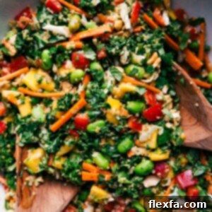 A beautifully presented bowl of Thai Quinoa Salad, vibrant with fresh vegetables, quinoa, and a rich peanut dressing, garnished with fresh herbs and cashews.