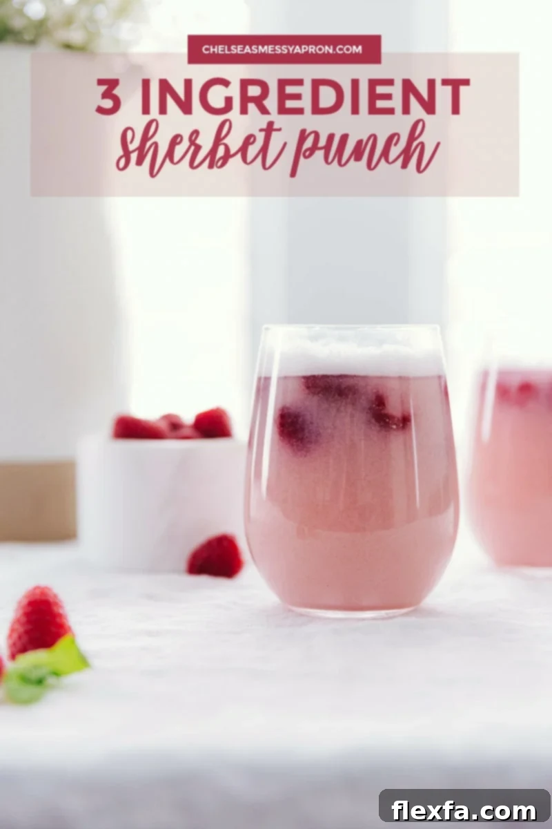 Two glasses of festive Sherbet Punch with fresh raspberry garnishes, ready to be served at a party.