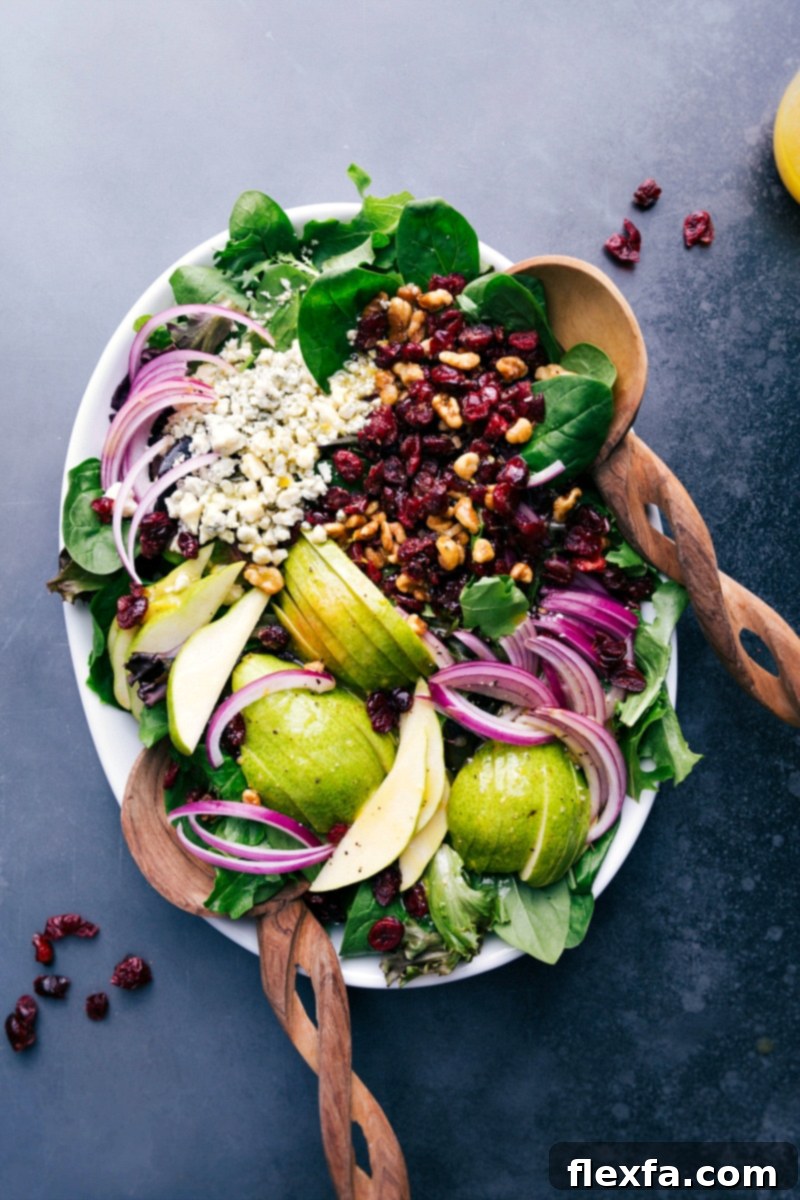 A vibrant and refreshing pear salad on a serving tray, garnished with fresh herbs, ready to be enjoyed.