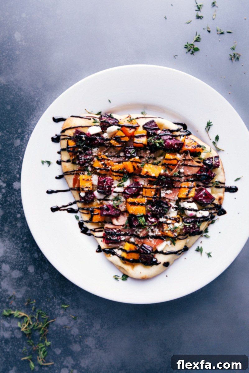 Overhead image of the finished beet and goat cheese flatbread, beautifully drizzled with rich balsamic glaze and artfully arranged on a serving platter, ready to be enjoyed