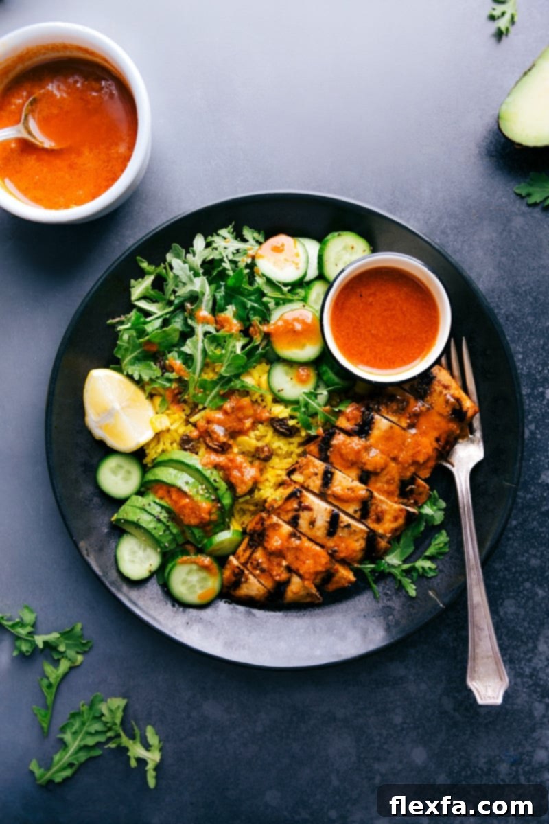 Chicken and Yellow Rice are the perfect dinner. A vibrant bowl filled with golden rice, grilled chicken, fresh greens, and a creamy sauce.