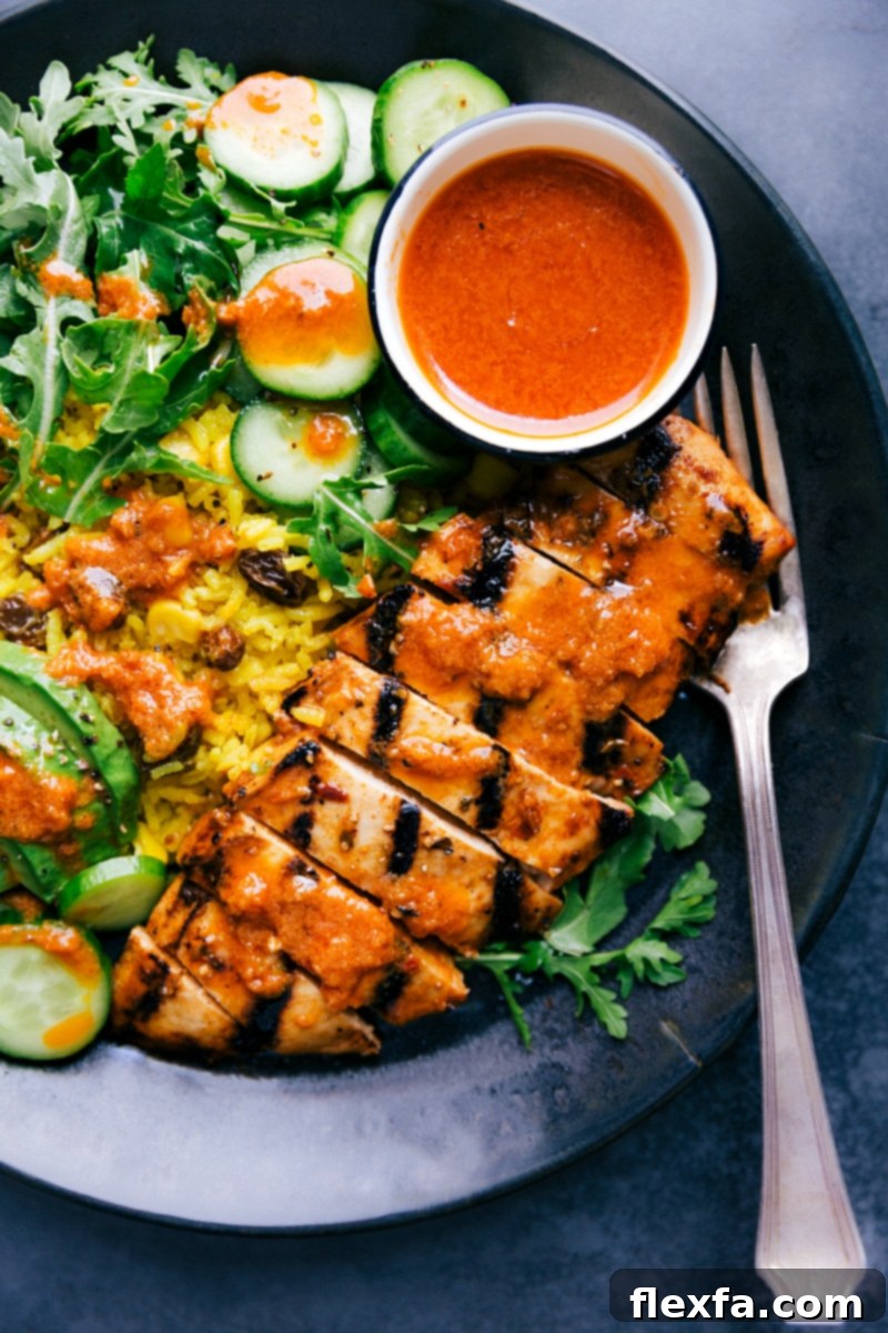 Chicken and Yellow Rice on a plate ready to be eaten, beautifully garnished.