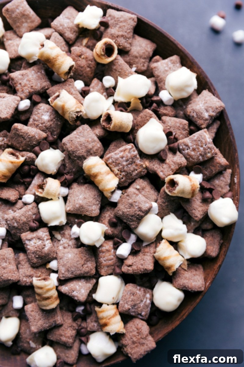 A close-up view of the finished Hot Chocolate Snack Mix, highlighting the texture of the chocolate-coated Chex cereal and the white chocolate-covered marshmallows.