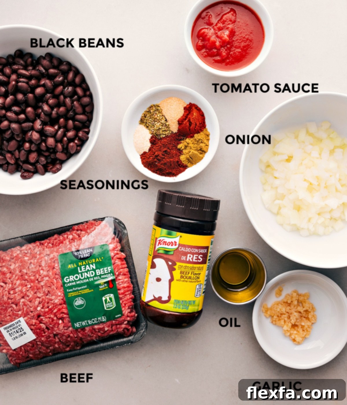 Ingredients In Taco Stuffed Sweet Potatoes All the ingredients for this recipe are prepped and ready for easy assembly, including tomato sauce, beef, onion, black beans, seasonings, oil, and garlic.
