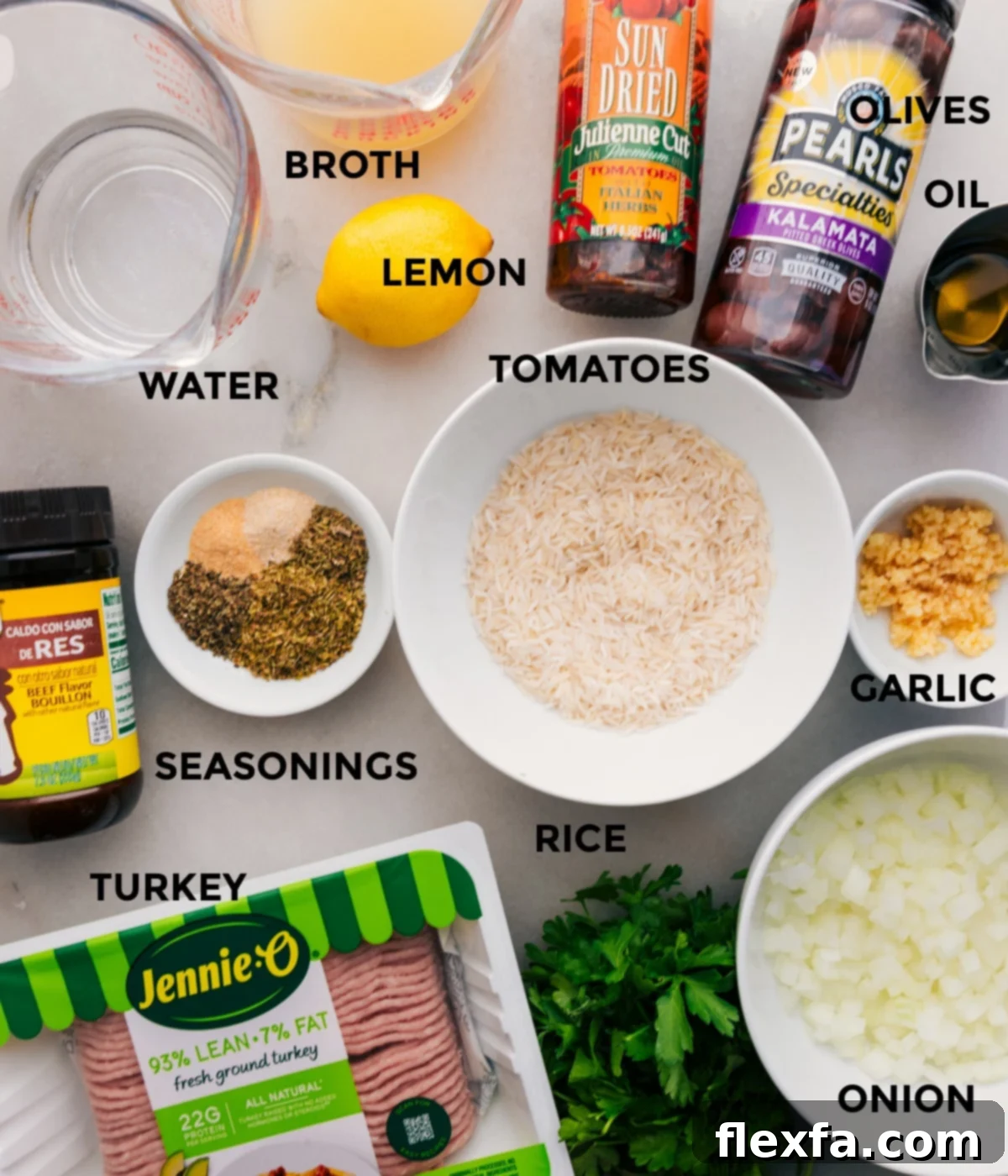 Prepped ingredients for Greek Ground Turkey Bowls, including cooked rice, seasoned ground turkey, fresh vegetables, olives, sun-dried tomatoes, and lemon.