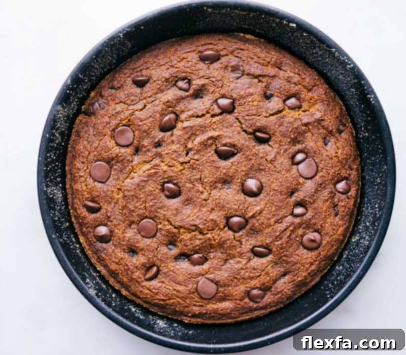 Delicious Gluten-Free Pumpkin Cake Fresh Out of the Oven A freshly baked gluten-free pumpkin cake, golden brown and radiating a warm aroma, resting on a wire rack to cool.