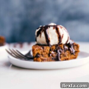 Gluten-free pumpkin cake on a plate, crowned with a scoop of ice cream, prepared for a delicious treat.