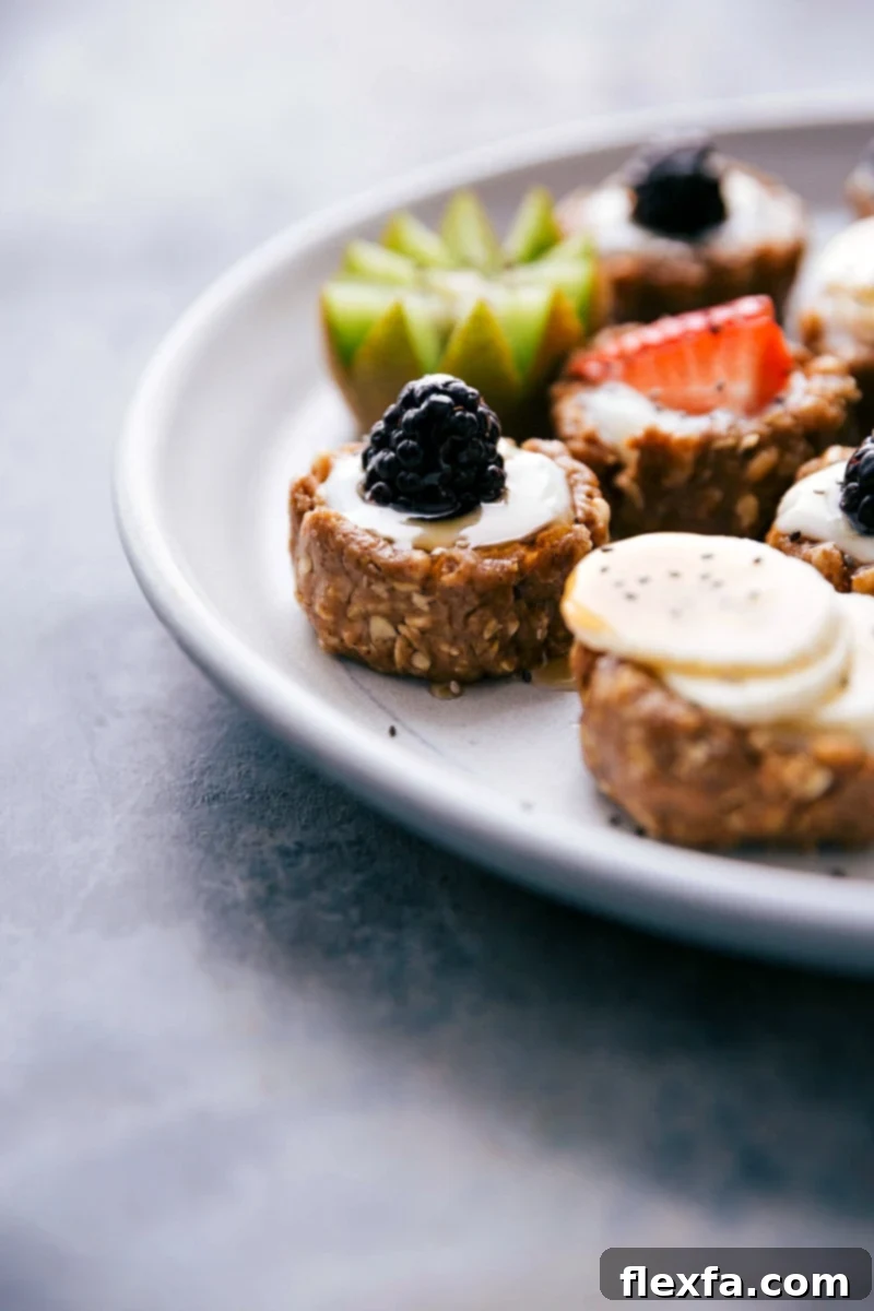 A beautifully arranged plate featuring multiple healthy fruit tarts, highlighting both the crunchy crusts and the luscious fresh fruit toppings.