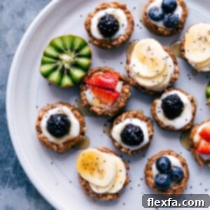 Healthy fruit tarts beautifully displayed on a tray, adorned with a variety of fresh fruit toppings.
