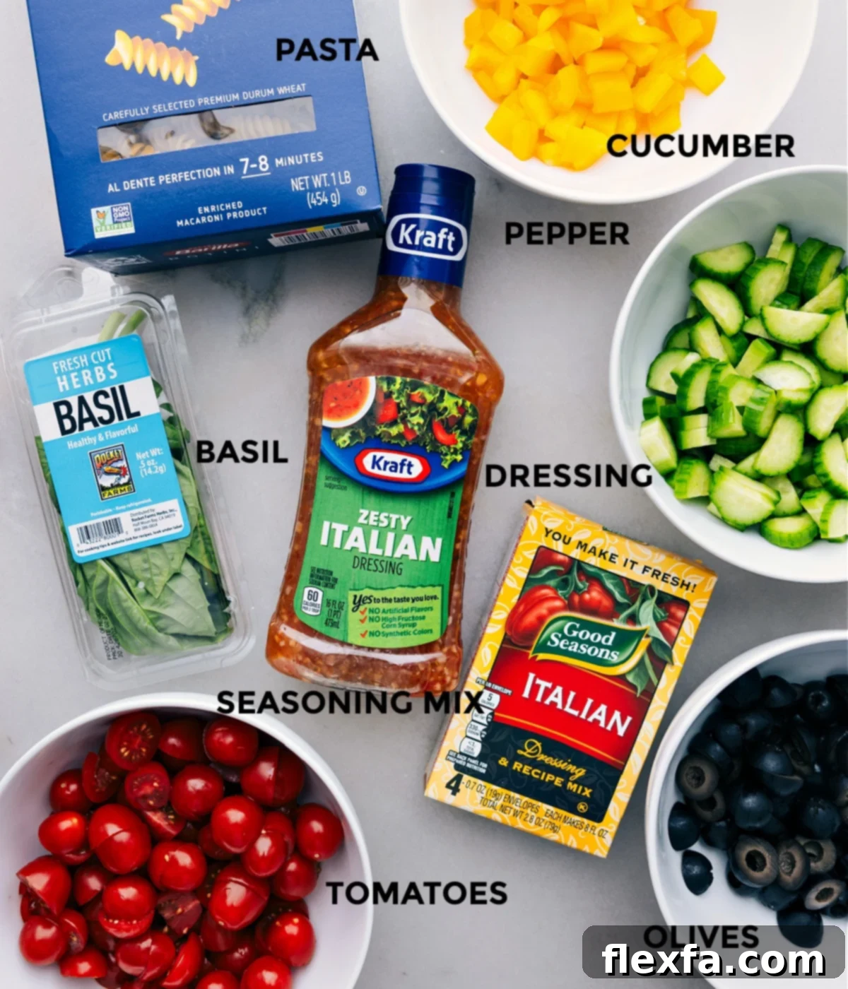 All the fresh ingredients for this pasta salad recipe, prepped and ready for quick assembly on a rustic wooden board.