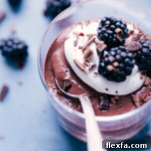 Chocolate Chia Seed Pudding topped with berries and whipped cream.