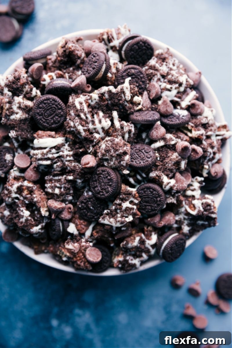 Overhead shot of Cookies and Cream Muddy Buddies piled high, showcasing their chocolate and Oreo coating.