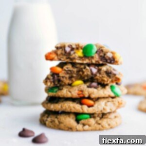 Healthy Monster Cookies stacked on top of each other with one broken in half showing off the middle.