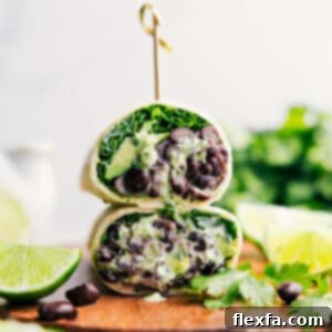 A vibrant Black Bean Wrap, halved and showing its delicious contents.