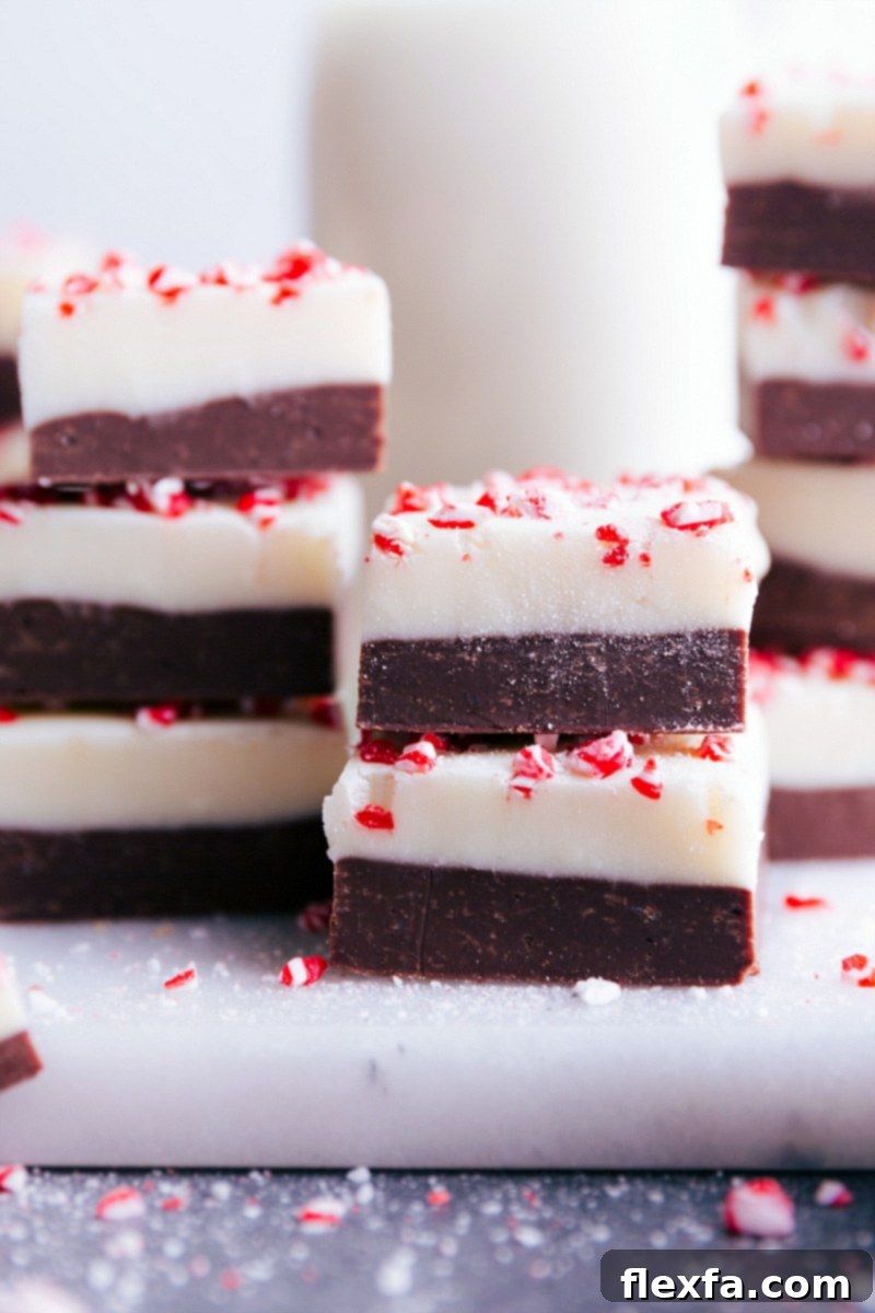 Beautifully cut squares of Peppermint Fudge, perfectly set and ready to be enjoyed, garnished with peppermint crunch.
