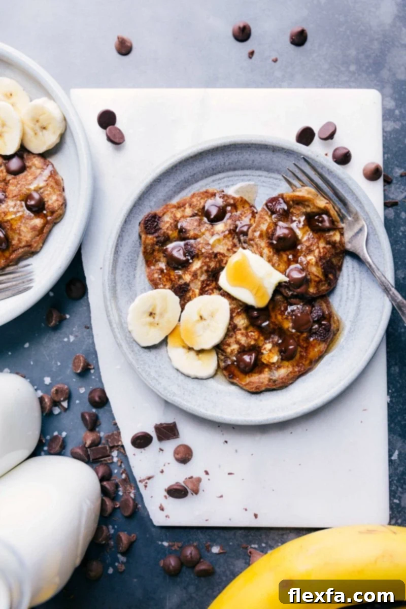 Delicious Gluten-Free Banana Pancakes with melted chocolate chips, topped with fresh banana slices and a drizzle of syrup, ready for breakfast.