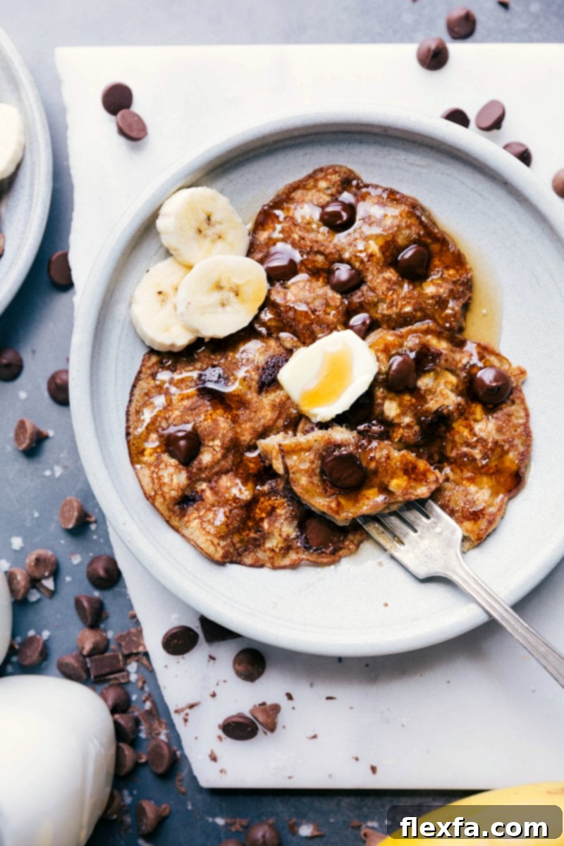 Warm and inviting Gluten-Free Banana Pancakes topped with a pat of butter and fresh banana slices, served for a delicious breakfast.