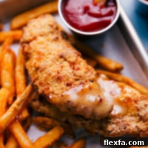 Golden crispy Air Fryer Chicken Tenders with honey mustard dipping sauce.