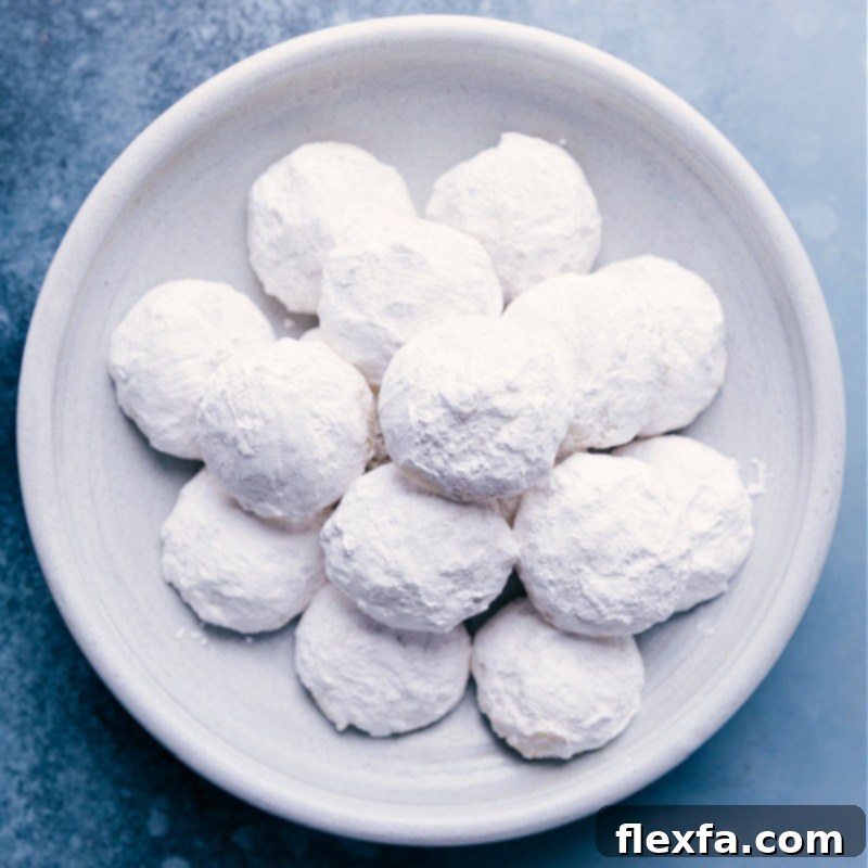 A plate featuring beautifully made Mexican Wedding Cookies, dusted with powdered sugar, ready for Easter gifting.